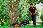 Photo of Craftsman lawn mower CM12AVB2C2093 in use on grass, red and black design, side view outdoors.