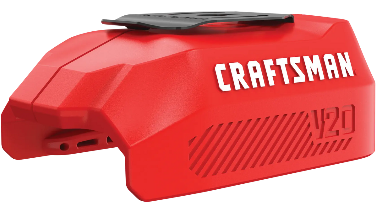 Photo of Craftsman V20 battery cover, SKU CMCB002B, in red plastic with black top, angled on white background.