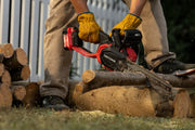 Photo of Craftsman CMCCS630P1 chainsaw cutting wood outdoors, operator wearing red Craftsman gloves.