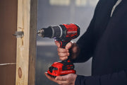 Photo of Craftsman cordless drill SKU CMCD732D2 being used to drill into wood, close-up view.