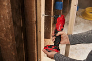 Photo of a person using a Craftsman cordless drill, SKU CMCD750B, drilling into a wooden stud at close-up angle.