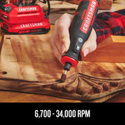 Craftsman rotary tool CMCE030B used for sanding wood carving, battery packs in background.