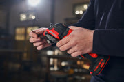 Photo of hands holding a Craftsman cordless power tool, SKU CMCE565B, indoors with blurred background.