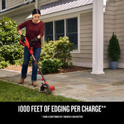 Photo of Craftsman electric edger SKU CMCED400B in use on lawn beside sidewalk, outdoor residential setting.