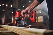 Photo of Craftsman CMCF813B cordless impact driver drilling into wood, shown in hands in workshop setting.