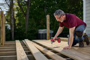 Photo of Craftsman CMCF830D2 impact driver used for deck construction, shown outdoors on wooden boards.