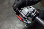 Photo of Craftsman angle grinder CMCG451B, close-up showing disc adjustment in workshop setting.