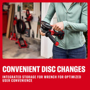 Photo of person changing disc on Craftsman cordless angle grinder CMCG452B, green jacket, workshop background.