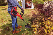 Photo of Craftsman CMCK197M1 string trimmer in use near garden bushes, outdoor storage shed in background.