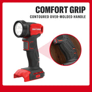 A CRAFTSMAN handheld cordless LED light is shown standing upright with a contoured over-molded handle highlighted for comfort grip. The product is black and red, with a close-up inset showing the textured grip area. Text at the top reads 'Comfort Grip Contoured Over-Molded Handle.'