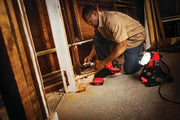 Photo of a Craftsman work light model CMCL030B illuminating a workspace during wall repair with visible construction tools.