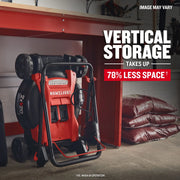 Photo of CRAFTSMAN CMCMW220P2 cordless lawn mower stored vertically under a workbench in a garage.