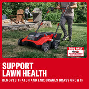 CRAFTSMAN CMCOE210B electric lawn dethatcher driven on grass by person, outdoor setting with patio in background.
