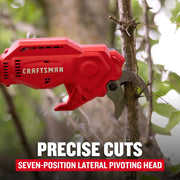 Craftsman red cordless pruning shear CMCPPR320D1 cutting branch outdoors, seven-position pivoting head.