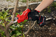 Photo of a Craftsman CMCPR320C1 cordless electric pruner cutting a tree branch outdoors, product held in gloved hand.