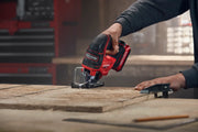 Photo of Craftsman cordless jigsaw CMCS650B cutting wood, close-up view in workshop setting.