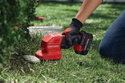 Photo of CRAFTSMAN CMCSS800C1 cordless grass shear during use on lawn, red and black handheld garden tool.