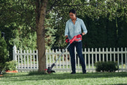 Photo of Craftsman cordless string trimmer CMCST915C1 used outdoors for lawn edging and trimming.