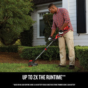 Photo of a person using Craftsman CMCST920B string trimmer, trimming grass along garden edge near a house.
