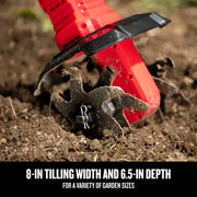 CRAFTSMAN garden tiller CMCTL320B close-up, red body and black blades tilling soil outdoors.