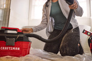 Photo of Craftsman wet/dry vacuum CMCV002B in use, shown from a side angle indoors.