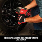 Craftsman CMEF901 impact wrench used on tire lug nuts, red and black tool, close up in automotive setting.