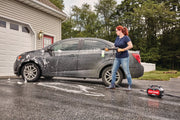 Photo of Craftsman CMEPW1700 pressure washer cleaning a car in a driveway, person holding spray wand.