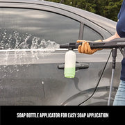 Photo of Craftsman CMEPW1700 pressure washer spraying water with soap bottle applicator attached, cleaning car door.