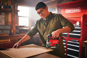 Photo of Craftsman jigsaw CMES612 in use on wood panel, workshop background with Craftsman tool chest.