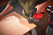 Photo of CRAFTSMAN CMES612 jigsaw cutting curved line in plywood, handheld in workshop setting.