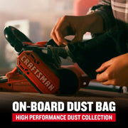 Craftsman CMEW213 belt sander with dust bag attached, shown in use on a wooden surface.