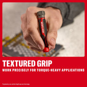 Hand holding a CRAFTSMAN screwdriver with textured grip for precise, torque-heavy tasks on a work surface.