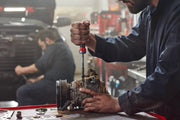 Photo of CRAFTSMAN CMHT68142V ratcheting screwdriver being used by mechanic on engine part in workshop.