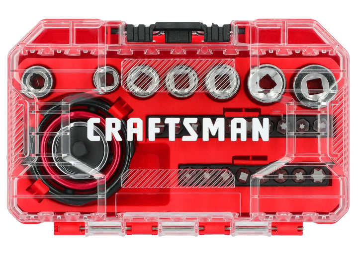 A clear plastic case with red interior containing a Craftsman socket and bit set. The set includes sockets, bits, and a ratchet with the Craftsman logo prominently displayed inside.