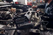 Craftsman CMMT45750V mechanic's socket and bit set in open case on car engine, automotive repair scene.