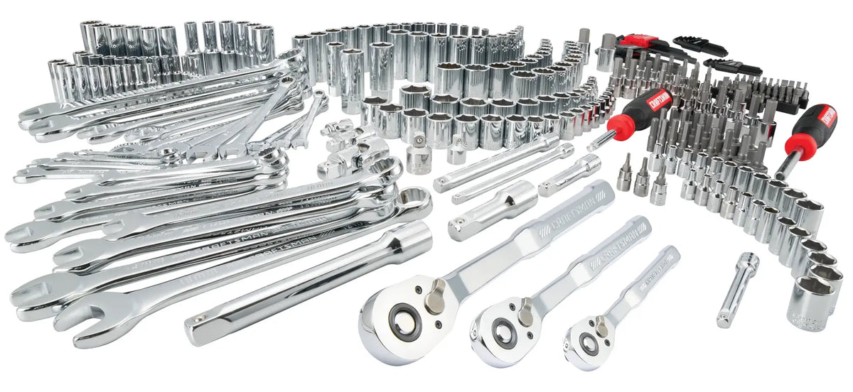 A large assortment of chrome hand tools including wrenches, ratchets, sockets, extensions, bit drivers, and screwdriver handles arranged on a white background.