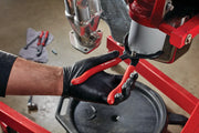 Photo of CRAFTSMAN oil filter wrench with red handles, SKU CMMT98303, used on automotive filter in workshop.