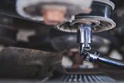 Close-up photo of Craftsman socket wrench in use, SKU CMMT99277, automotive tool detail.