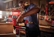 Photo of a Craftsman CMPBN18K brad nailer in use in a workshop, red and black tool connected to air hose.