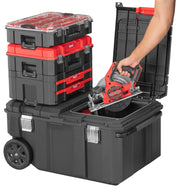 Photo of Craftsman stackable black and red toolboxes, SKU CMST17870, with open rolling toolbox and hand placing circular saw inside, front angle.