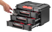 Photo of CRAFTSMAN CMST21405 drawer tool box, black and red, with open drawers and hand holding pliers, front angle.