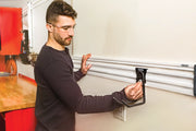 Photo of Craftsman wall storage rail CMST22000 with hook attachment being adjusted in a workshop setting.