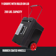 Craftsman rolling toolbox CMST33026 with black body, red rubber-coated wheels, V-groove lid, ruler. Angle view.