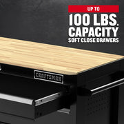 Craftsman graphics CMST98278BK showing black workbench with wood top and soft close drawer, angled view.