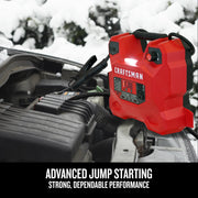 Photo of CRAFTSMAN jump starter CMXCESM256 connected to car battery in snowy outdoor setting.