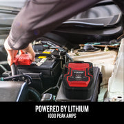 Photo of CRAFTSMAN CMXCESM263 jump starter in use on car battery, black and red unit, automotive setting.