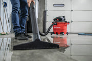 Photo of Craftsman wet/dry vacuum CMXEVBE17607 in use on a wet garage floor, showing the vacuum and cleaning nozzle.