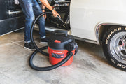 Photo of Craftsman wet/dry vacuum CMXEVBE17925 being used to clean a car interior, garage setting.