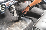 Photo of CRAFTSMAN CMXEVBE17925 vacuum cleaning car floor mat with brush nozzle attachment.