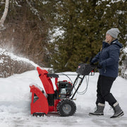 Photo of Craftsman CMXGBAM213102 snow blower in use outdoors, red body, clearing snow in winter.